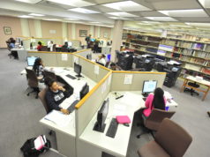 Wide shot of library computers with students